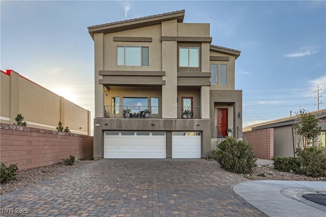 contemporary home featuring a balcony and a garage