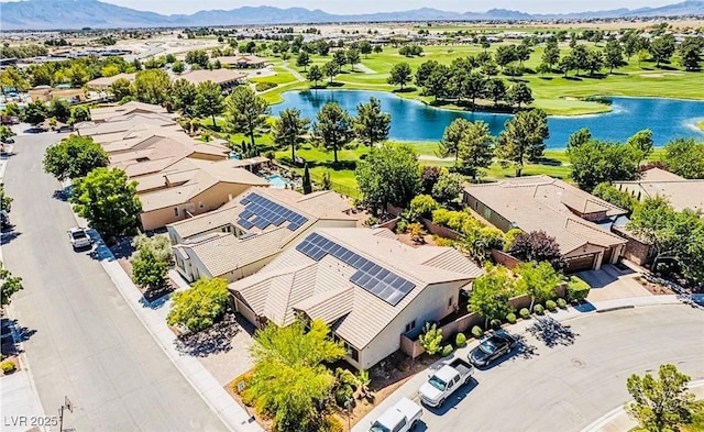 drone / aerial view with a residential view, view of golf course, and a water and mountain view