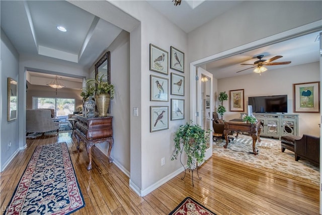 hall with baseboards and hardwood / wood-style floors