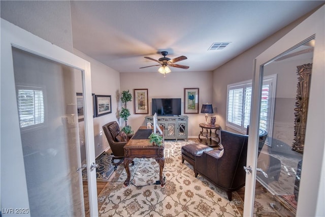 living room featuring wood-type flooring and ceiling fan