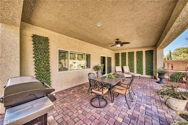 view of patio / terrace with ceiling fan, outdoor dining space, fence, and a grill