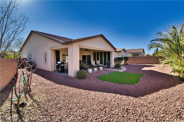 back of property with ceiling fan, a patio, a fenced backyard, and stucco siding