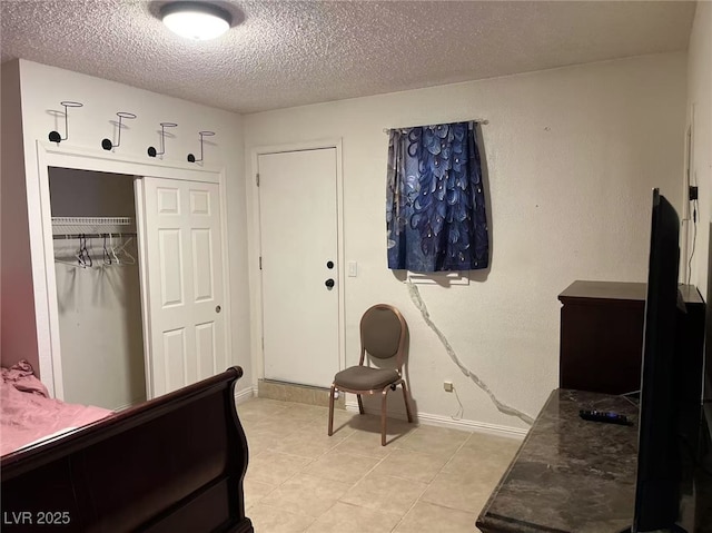 bedroom with a textured ceiling and a closet