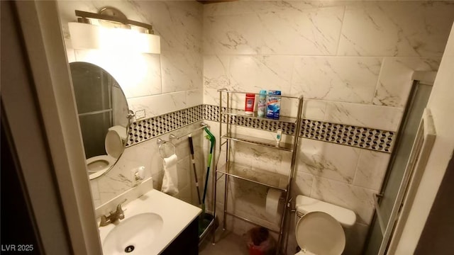 bathroom featuring toilet, walk in shower, and sink