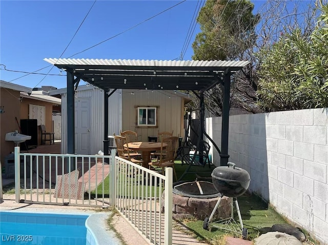 rear view of property with a fenced in pool and a fire pit