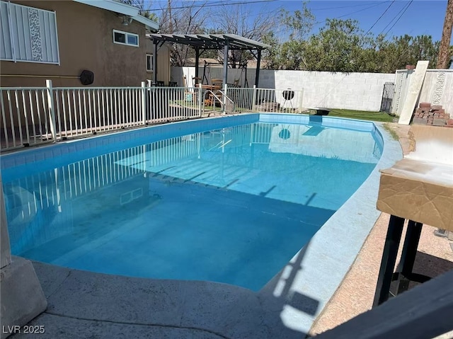 view of swimming pool with a pergola