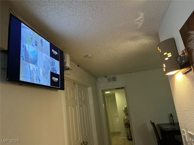 interior space with a textured ceiling