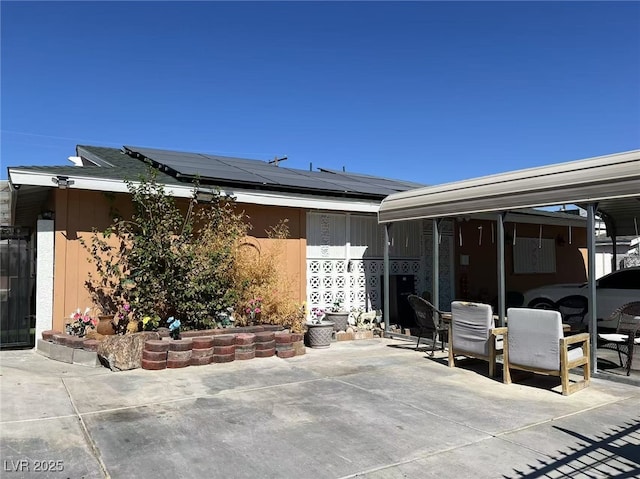 exterior space featuring solar panels and a patio