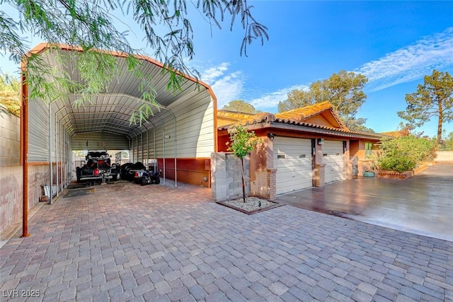 view of side of home featuring a carport and a garage