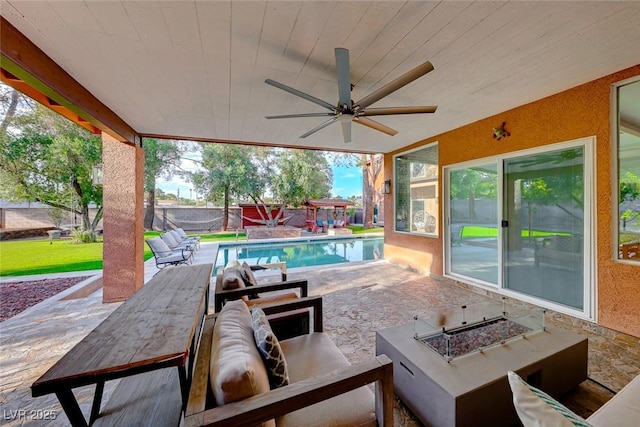 view of patio featuring ceiling fan and a fire pit