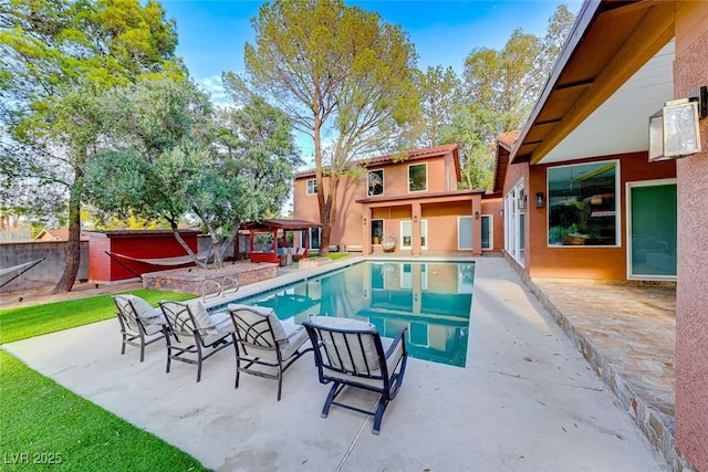 view of swimming pool featuring a patio area and a gazebo