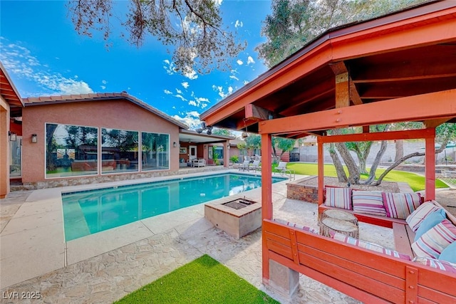 view of pool with a patio area, a gazebo, and an outdoor living space with a fire pit