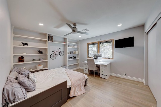 bedroom featuring ceiling fan, light hardwood / wood-style flooring, and a closet