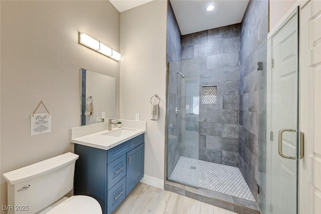 bathroom with toilet, a shower with door, and vanity