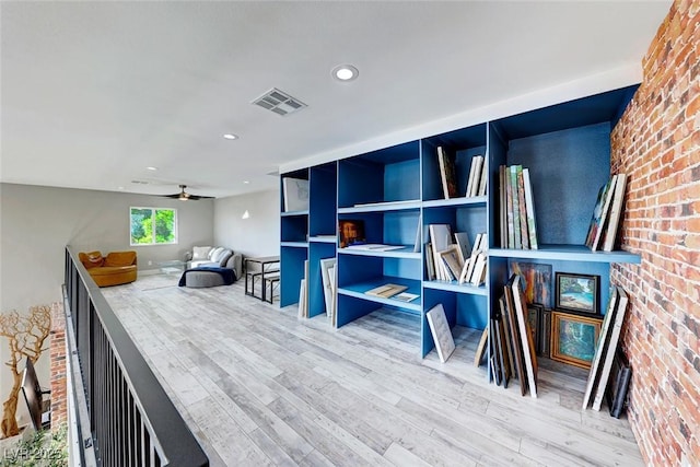 recreation room featuring ceiling fan and hardwood / wood-style flooring