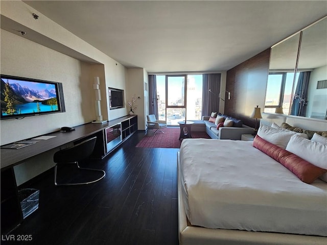 living room featuring floor to ceiling windows and dark hardwood / wood-style flooring