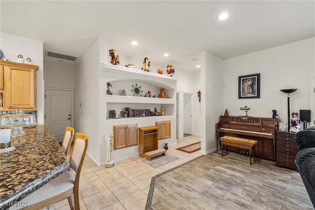 interior space with light tile patterned floors and built in features