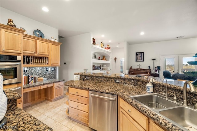 kitchen with appliances with stainless steel finishes, decorative backsplash, sink, light brown cabinetry, and light tile patterned floors