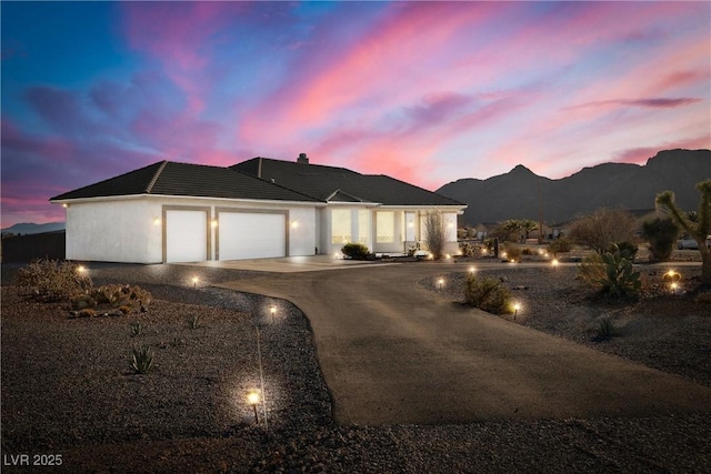 view of front of house with a garage and a mountain view