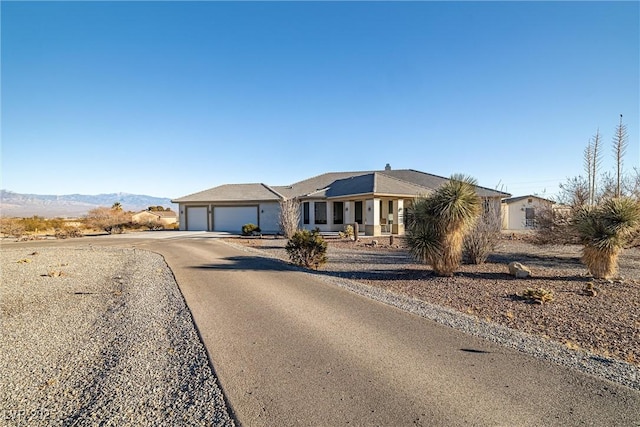 single story home with a mountain view and a garage