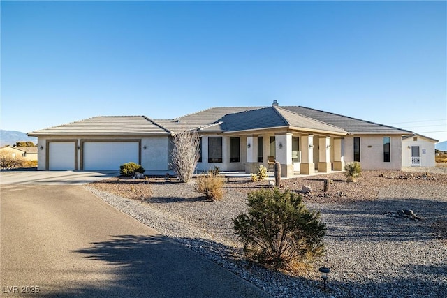 ranch-style house with covered porch and a garage