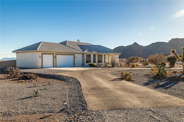 ranch-style home with a mountain view and a garage