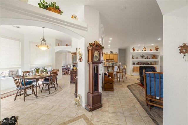 dining area with light tile patterned floors and built in features