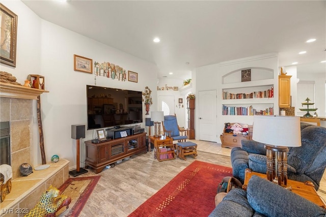 living room featuring built in shelves and a fireplace