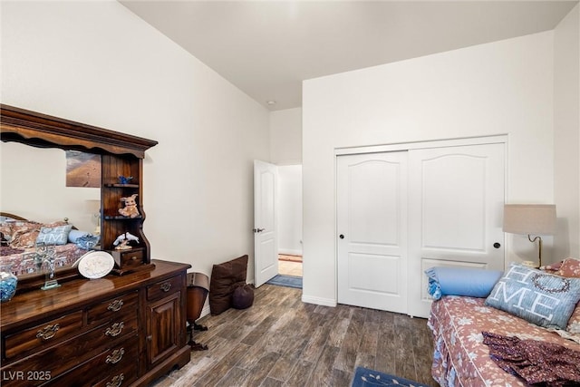 bedroom with a closet and dark hardwood / wood-style flooring