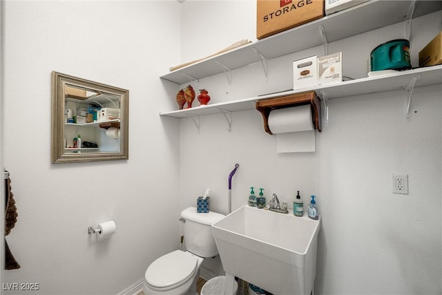 bathroom featuring toilet and sink