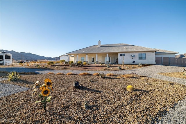 back of property featuring a mountain view