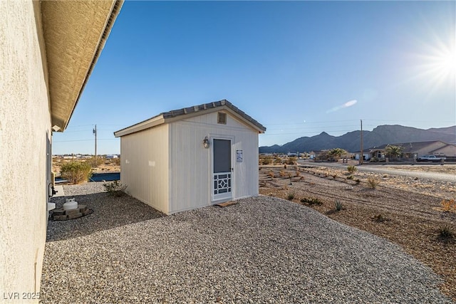 view of outbuilding featuring a mountain view