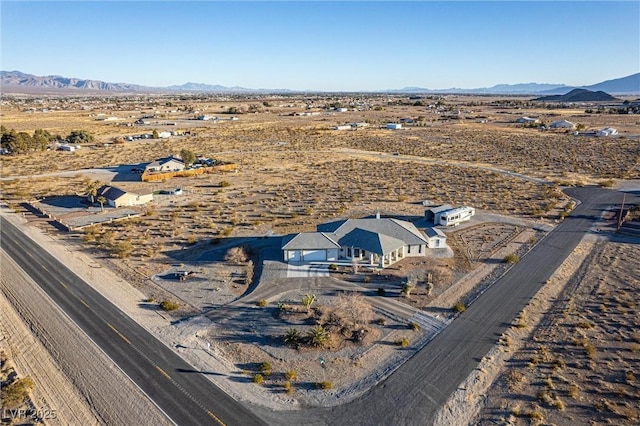 birds eye view of property with a mountain view