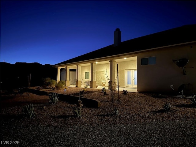 view of back house at twilight