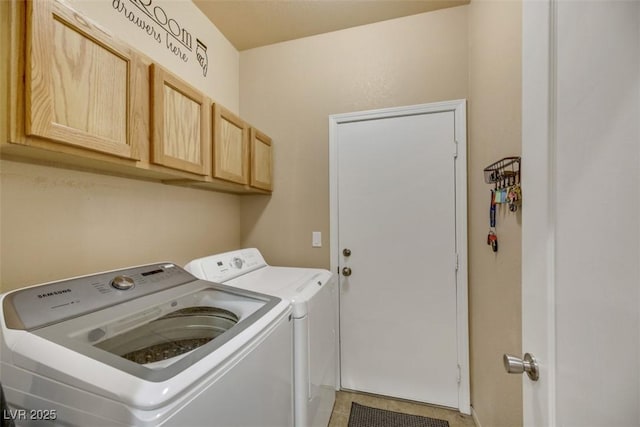 laundry area featuring tile patterned floors, independent washer and dryer, and cabinets