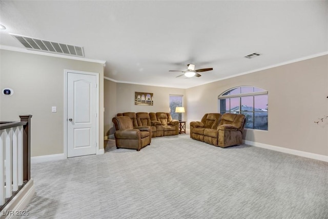 carpeted living room with ceiling fan and ornamental molding