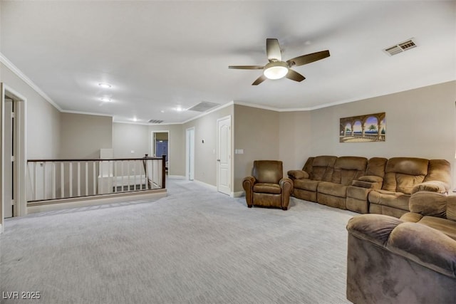 living room with ceiling fan, ornamental molding, and light colored carpet