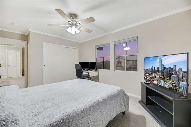 bedroom featuring light carpet, ceiling fan, a closet, and crown molding