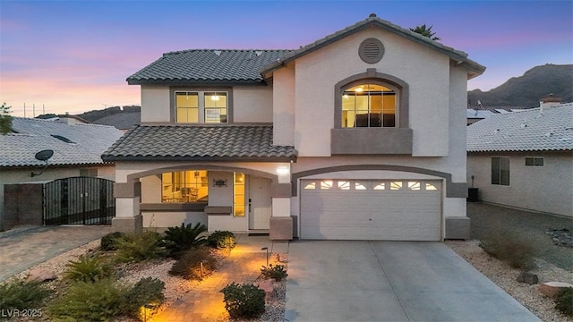 view of front facade featuring a garage and a mountain view