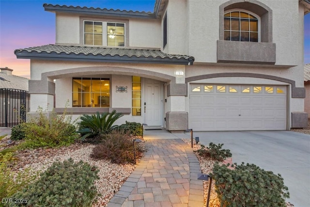 mediterranean / spanish-style home with a garage