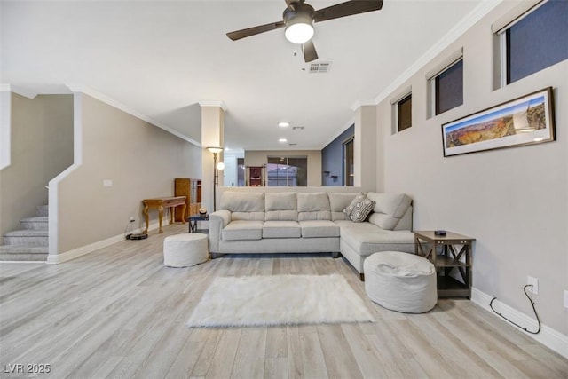 living room featuring ceiling fan, crown molding, and light hardwood / wood-style floors