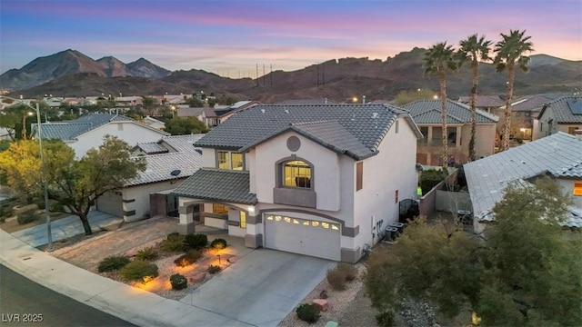 view of front of home with a mountain view and a garage