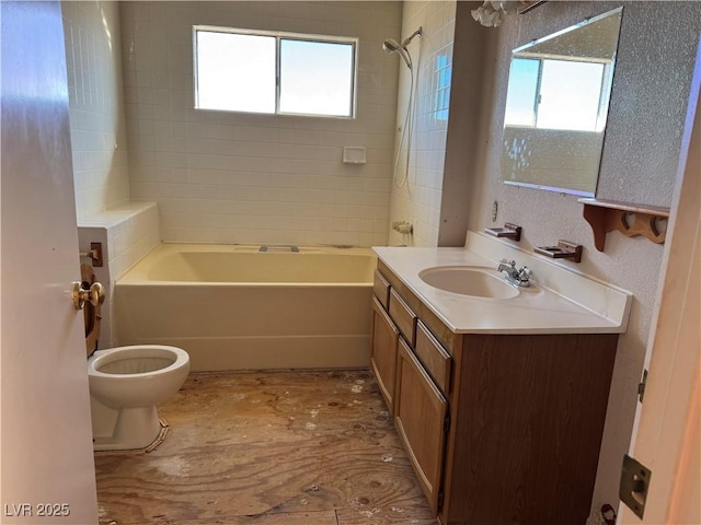 full bathroom with toilet, vanity, and tiled shower / bath