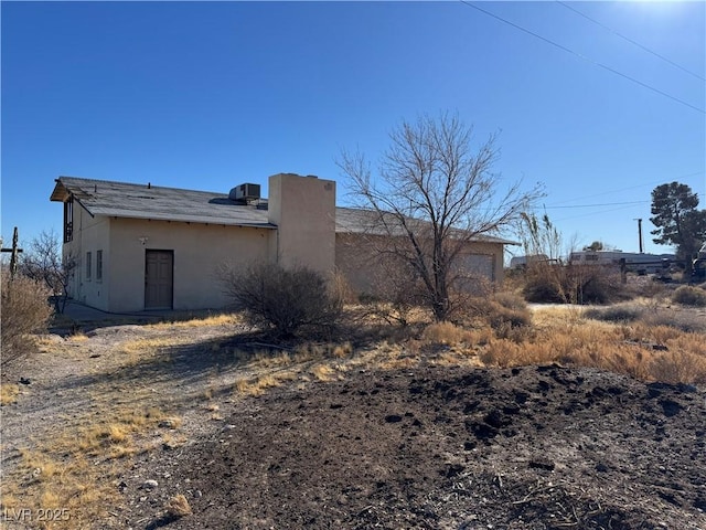 rear view of house featuring central AC unit