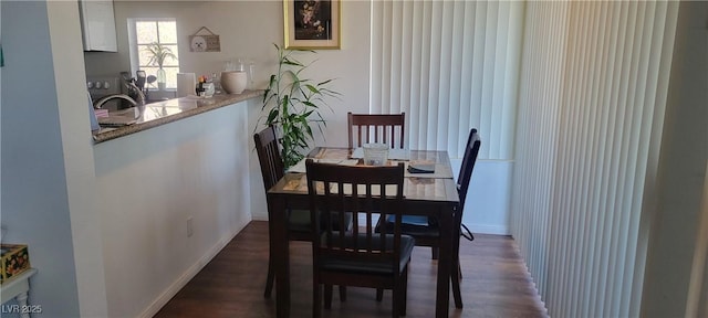 dining space with sink and dark hardwood / wood-style flooring