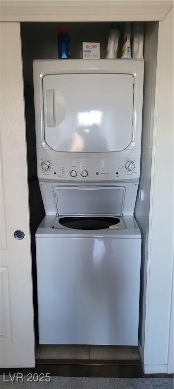 laundry area with stacked washer and dryer