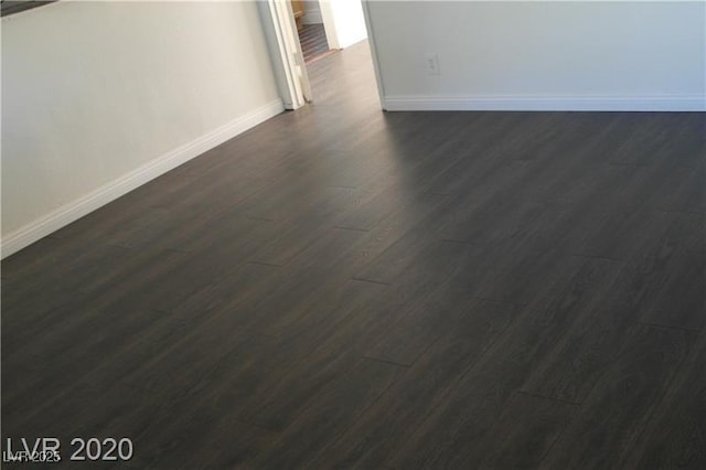 spare room featuring dark wood-type flooring