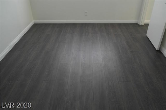 spare room with dark wood-type flooring