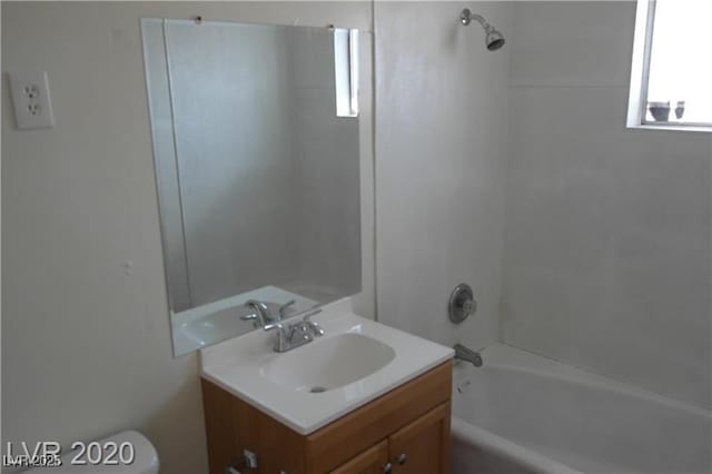 full bathroom featuring toilet, vanity, and bathtub / shower combination