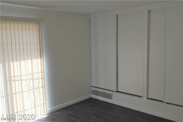 unfurnished room featuring dark hardwood / wood-style flooring